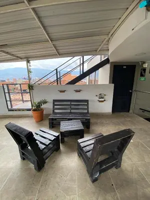 a living room with two chairs and a bench at 33 Hotel Bulerias in Medellín