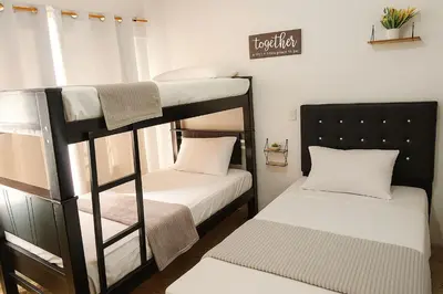 two bunk beds in a room with a window at Two modern furnished apartments in Medellín
