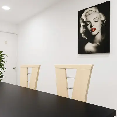 a dining room with a black table and two stools at Two modern furnished apartments in Medellín
