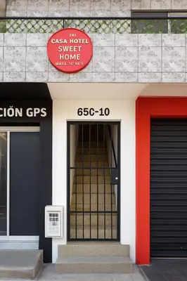 a building with two doors and a red sign on it at Two modern furnished apartments in Medellín