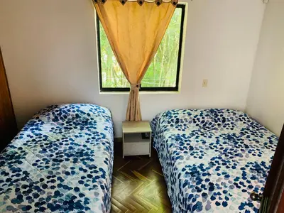 a bedroom with two beds and a window at Casa Campestre Poblado para 10H San Lucas 106 in Medellín
