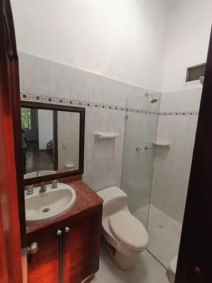 a bathroom with a toilet and a sink and a shower at Casa Campestre Poblado para 10H San Lucas 106 in Medellín