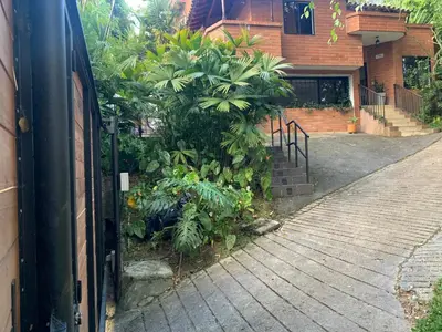 a house with a bunch of plants in front of it at Casa Campestre Poblado para 10H San Lucas 106 in Medellín