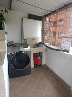a washing machine in a small kitchen with a window at Acogedor Aparta Hotel 6H terraza Belén Rosales apt 300 in Medellín