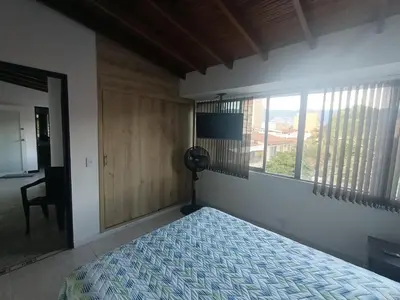 a bedroom with a bed and a window at Acogedor Aparta Hotel 6H terraza Belén Rosales apt 300 in Medellín