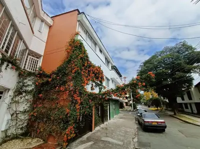 a building with a plant growing on the side of it at Acogedor Aparta Hotel 6H terraza Belén Rosales apt 300 in Medellín