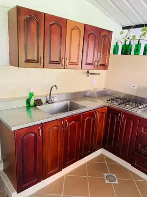 a kitchen with wooden cabinets and a sink at Acogedor Aparta Hotel 6H terraza Belén Rosales apt 300 in Medellín