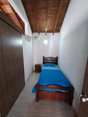 a small bedroom with a blue bed in a room at Apartamento en el Estadio-Obelisco in Medellín