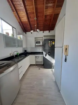 a kitchen with white appliances and a wooden ceiling at Apartamento en el Estadio-Obelisco in Medellín