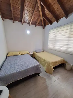 a bedroom with two beds and a window in it at Apartamento en el Estadio-Obelisco in Medellín