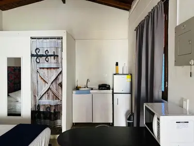 a small kitchen with a refrigerator and a table at Aloja-T en Apartaloft amoblado en Jericó in Jericó