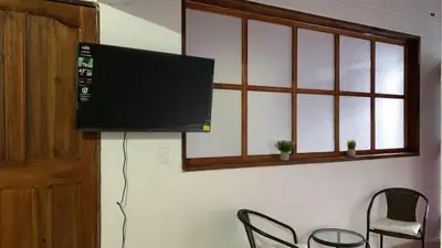 a flat screen tv hanging on a wall at Aloja-T en Apartaloft amoblado en Jericó in Jericó