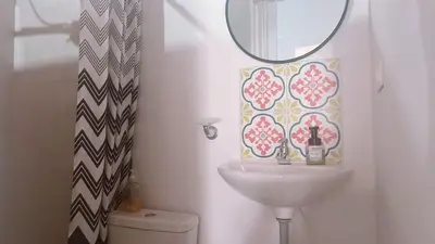 a bathroom with a sink and a mirror and a toilet at Aloja-T en Apartaloft amoblado en Jericó in Jericó