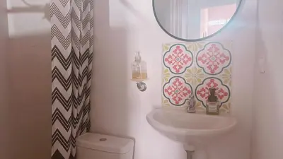 a bathroom with a sink and a mirror and a toilet at Aloja-T en Apartaloft amoblado en Jericó in Jericó