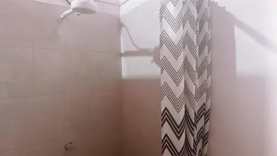 a shower with a black and white patterned shower curtain at Aloja-T en Apartaloft amoblado en Jericó in Jericó
