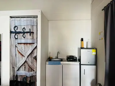 a kitchen with a refrigerator and a sliding door at Aloja-T en Apartaloft amoblado en Jericó in Jericó