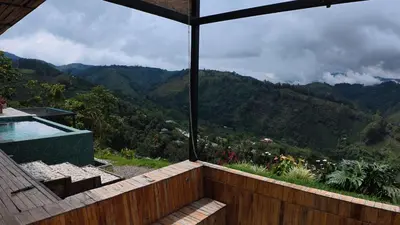 a balcony with a view of a mountain at GLAMPING ENTRE MONTES Y CAFETALES in Santuario