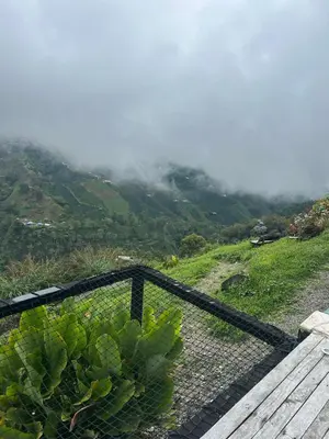 a fence with a view of a mountain at GLAMPING ENTRE MONTES Y CAFETALES in Santuario