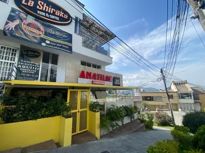 a yellow building with aania sign in front of it at LA CASA DEL CABLE -Atractivo Único Apartamento Sector Cable in Manizales