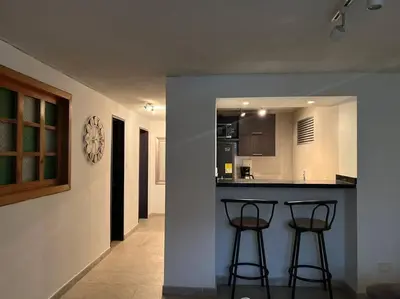 a kitchen with two bar stools at a counter at LA CASA DEL CABLE -Atractivo Único Apartamento Sector Cable in Manizales