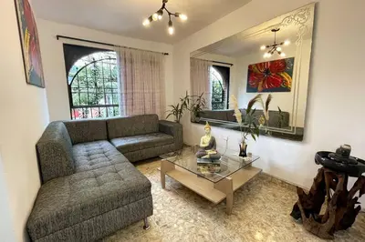 a living room with a couch and a coffee table at Medellin Tu hogar en la eterna primavera in Medellín