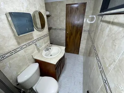 a bathroom with a toilet and a sink and a tv at Medellin Tu hogar en la eterna primavera in Medellín