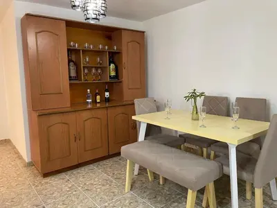 a dining room with a table and some wine bottles at Medellin Tu hogar en la eterna primavera in Medellín