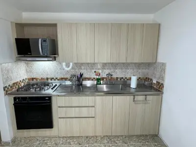 a kitchen with a sink and a stove at Medellin Tu hogar en la eterna primavera in Medellín