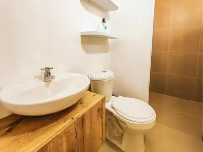 a bathroom with a sink and a toilet at Aparta Hotel Guatape Faith 101 by Hope in Guatapé