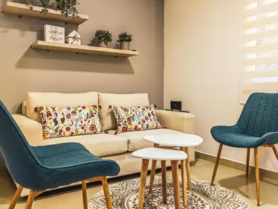 a living room with a couch and two chairs at Aparta Hotel Guatape Faith 101 by Hope in Guatapé