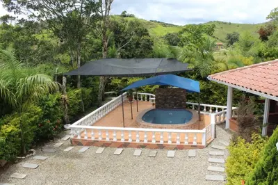 a patio with an umbrella and a swimming pool at Casa Alejandria in Alejandría
