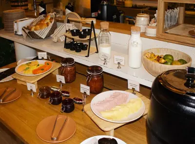 a buffet of food with bread and other foods at The Somos Central Hotel Poblado in Medellín
