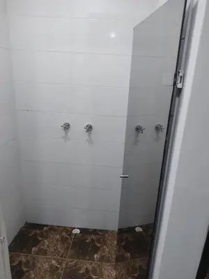 a bathroom with a shower with a glass door at Hotel Spa Laureles in Medellín