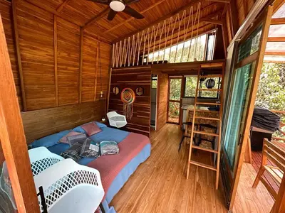 a room with a bed and a desk in a cabin at Eco Hotel Samaria , Aguas y Bosques in San Rafael