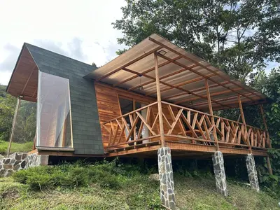 a house with a large deck on a hill at Eco Hotel Samaria , Aguas y Bosques in San Rafael