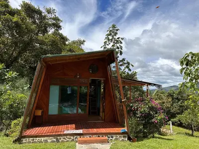 a small cabin with a glass door in the grass at Eco Hotel Samaria , Aguas y Bosques in San Rafael