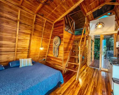 a bedroom with a bed and a wooden wall at Eco Hotel Samaria , Aguas y Bosques in San Rafael