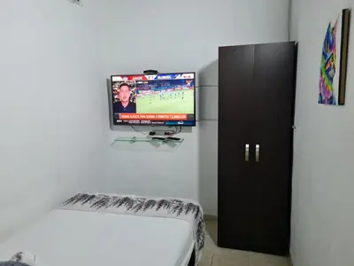 a room with a flat screen tv on a wall at NEW COZY APARTMENT 101 IN MEDELLIN, ENVIGADO in Envigado