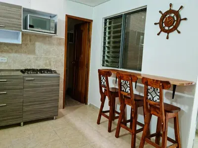 a kitchen with a wooden table and four chairs at NEW COZY APARTMENT 101 IN MEDELLIN, ENVIGADO in Envigado