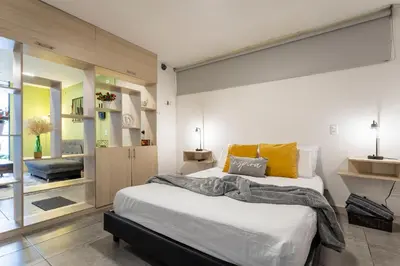 a bedroom with a large bed in a room at Tranvia 40 - Amoblados Velasquez in Medellín