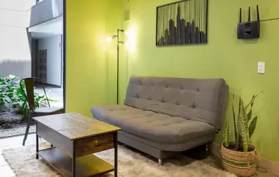 a living room with a couch and a table at Tranvia 40 - Amoblados Velasquez in Medellín