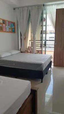 a bedroom with two beds and a balcony at Disfruta en Paraíso del Sol T9-402 in San Jerónimo