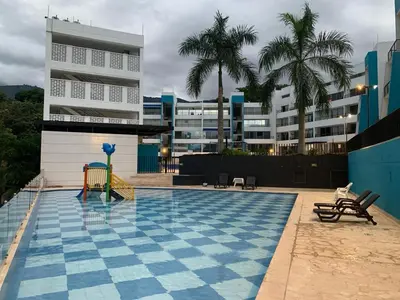 a swimming pool with a blue and white tile floor at Disfruta en Paraíso del Sol T9-402 in San Jerónimo