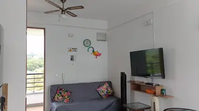 a living room with a couch and a flat screen tv at Disfruta en Paraíso del Sol T9-402 in San Jerónimo