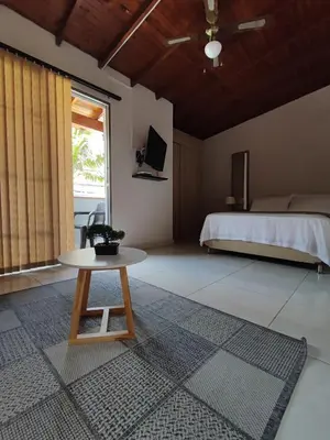 a bedroom with a bed and a table in a room at apartamento loft a media cuadra de la estación floresta in Medellín