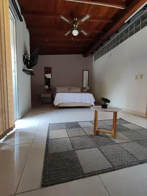 a bedroom with a bed and a table in a room at apartamento loft a media cuadra de la estación floresta in Medellín
