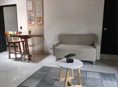 a living room with a couch and a table at apartamento loft a media cuadra de la estación floresta in Medellín