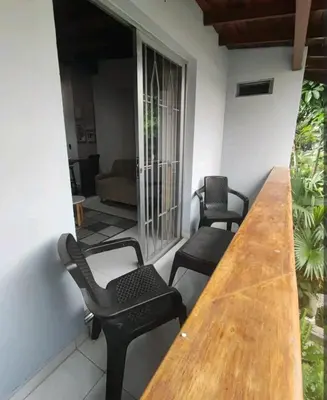 a room with a wooden table and two chairs at apartamento loft a media cuadra de la estación floresta in Medellín