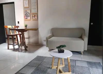 a living room with a couch and a table at apartamento loft a media cuadra de la estación floresta in Medellín
