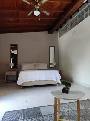a bedroom with a bed and a table at apartamento loft a media cuadra de la estación floresta in Medellín